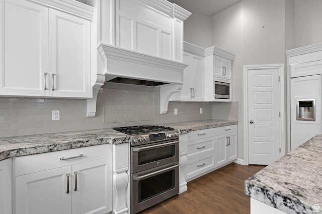 5575 S 1350 E, South Ogden, UT 84403 - kitchen featuring built in appliances, tasteful backsplash, white cabinetry, dark wood finished floors, and light stone counters