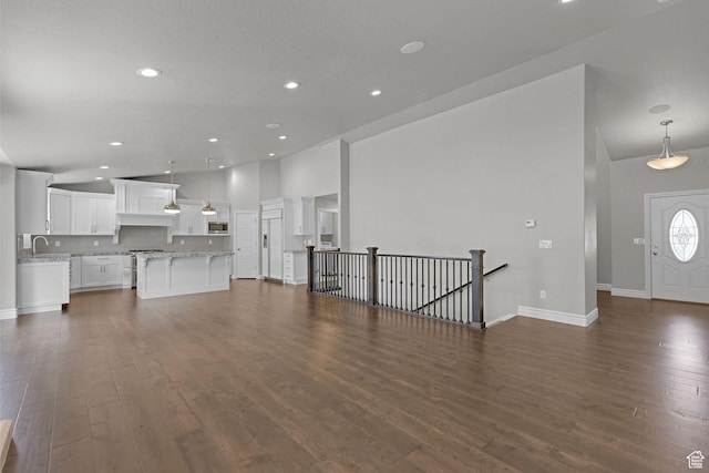 5575 S 1350 E, South Ogden, UT 84403 - unfurnished living room with high vaulted ceiling, recessed lighting, and dark wood-style floors
