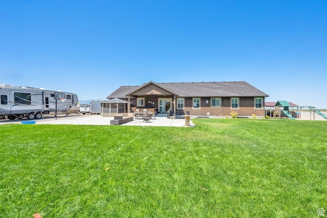 4390 N Diamond Ln, Erda, UT 84074 - rear view of house featuring a patio, a playground, a yard, and a sunroom
