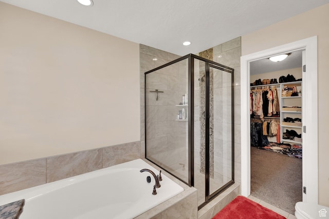 4390 N Diamond Ln, Erda, UT 84074 - bathroom featuring a bath, a stall shower, a spacious closet, and recessed lighting