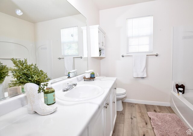 1568 Dawson Ln, Tooele, UT 84074 - bathroom with vanity, wood finished floors, healthy amount of natural light, and shower / washtub combination