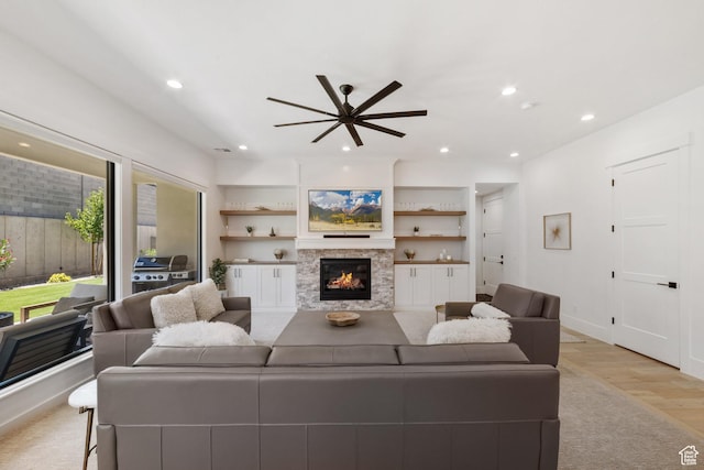 2950 E Naboo Ln, St George, UT 84790 - living area with light wood-type flooring, a ceiling fan, a glass covered fireplace, and recessed lighting