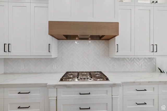 2950 E Naboo Ln, St George, UT 84790 - kitchen featuring ventilation hood, white cabinets, stainless steel gas cooktop, and backsplash