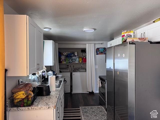 54 W 300 S, Orem, UT 84058 - kitchen with freestanding refrigerator, washer and dryer, white cabinetry, and dark wood-type flooring