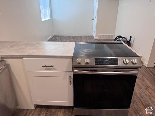 54 W 300 S, Orem, UT 84058 - kitchen featuring electric stove, dark wood-style floors, white cabinets, and light countertops