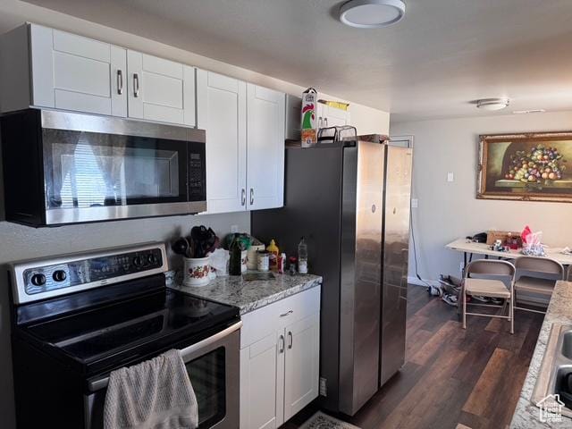 54 W 300 S, Orem, UT 84058 - kitchen with appliances with stainless steel finishes, white cabinetry, dark wood finished floors, and light stone counters