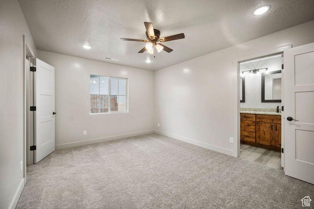 775 E 100 N Unit 83, Enterprise, UT 84725 - unfurnished bedroom featuring light colored carpet, a textured ceiling, connected bathroom, recessed lighting, and a ceiling fan