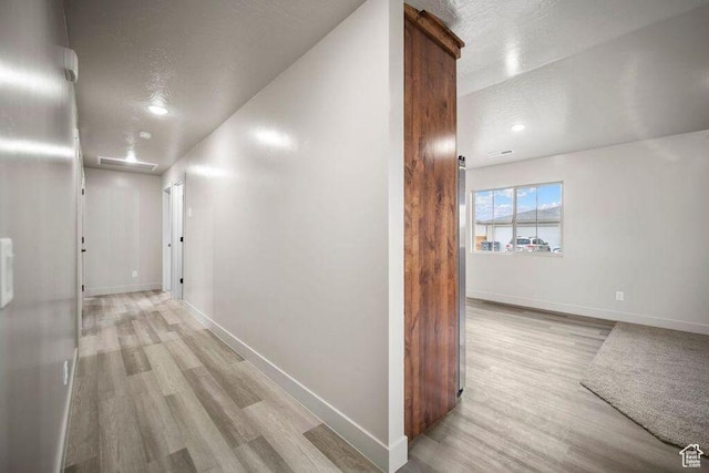 775 E 100 N Unit 83, Enterprise, UT 84725 - hallway with light wood-style flooring and a textured ceiling
