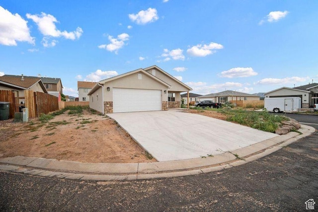 775 E 100 N Unit 83, Enterprise, UT 84725 - ranch-style home with stone siding, concrete driveway, stucco siding, an attached garage, and a residential view
