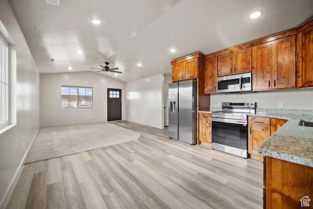 775 E 100 N Unit 83, Enterprise, UT 84725 - kitchen featuring stainless steel appliances, light wood finished floors, a ceiling fan, vaulted ceiling, and brown cabinets