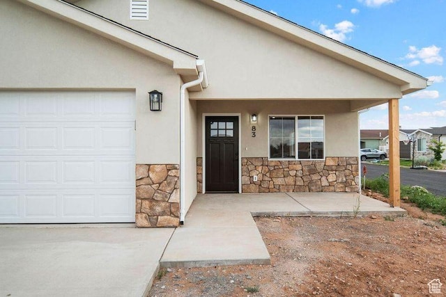 775 E 100 N Unit 83, Enterprise, UT 84725 - doorway to property with stone siding, stucco siding, and a garage