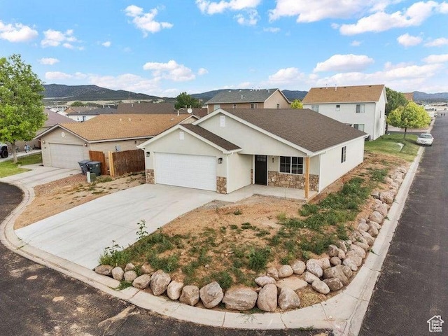 775 E 100 N Unit 83, Enterprise, UT 84725 - view of front of house with stone siding, a garage, a porch, and concrete driveway