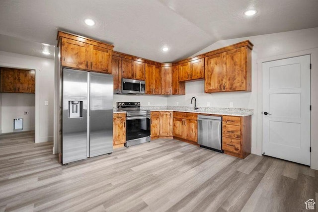 775 E 100 N Unit 83, Enterprise, UT 84725 - kitchen with appliances with stainless steel finishes, light wood-style floors, vaulted ceiling, brown cabinetry, and recessed lighting