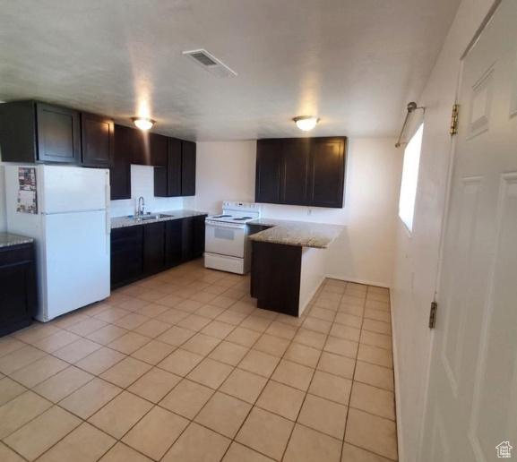 275 N 100 W Unit 1-6, Spanish Fork, UT 84660 - kitchen with white appliances, a peninsula, light tile patterned floors, and light stone counters