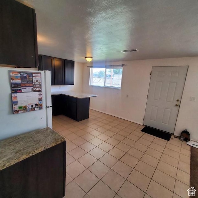 275 N 100 W Unit 1-6, Spanish Fork, UT 84660 - kitchen with a peninsula, light countertops, light tile patterned floors, and a textured ceiling