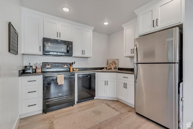 1058 W 570 N, Orem, UT 84057 - kitchen with black appliances, light wood finished floors, dark countertops, white cabinetry, and recessed lighting