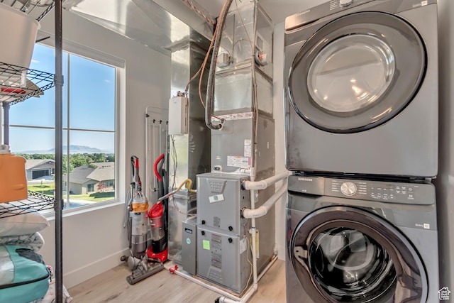1058 W 570 N, Orem, UT 84057 - laundry room with stacked washing machine and dryer and wood finished floors