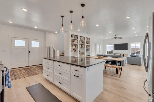 1058 W 570 N, Orem, UT 84057 - kitchen with dark countertops, recessed lighting, freestanding refrigerator, light wood-type flooring, and white cabinets