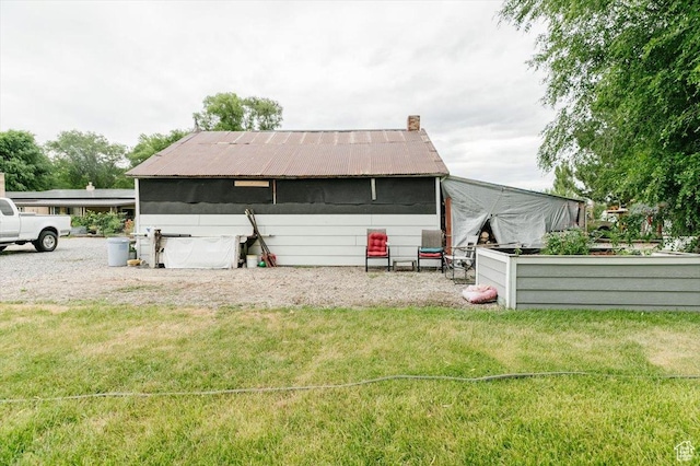 14360 N 6000 W, Garland, UT 84312 - back of property featuring a yard, a metal roof, and a chimney
