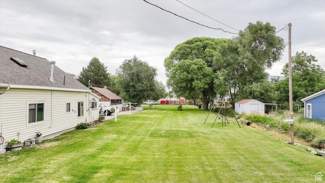 14360 N 6000 W, Garland, UT 84312 - view of grassy yard with a storage shed