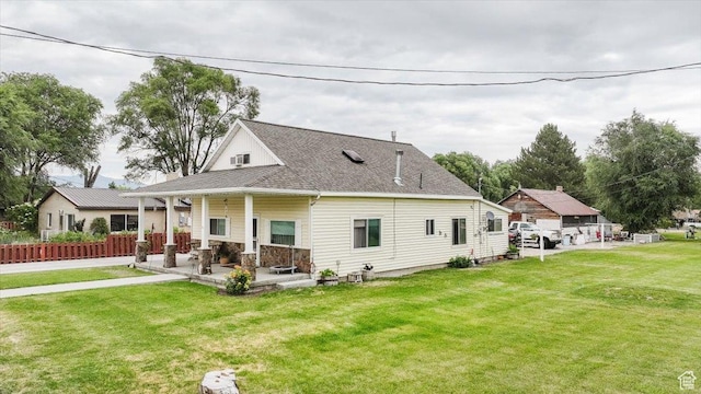 14360 N 6000 W, Garland, UT 84312 - rear view of house with a lawn, roof with shingles, and covered porch