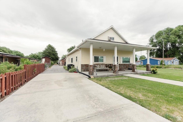 14360 N 6000 W, Garland, UT 84312 - view of front of home with stone siding, a porch, and concrete driveway