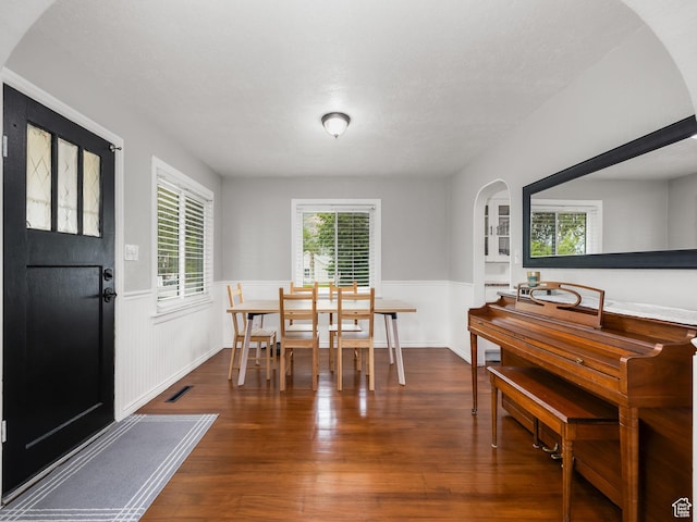 188 E 100 S, Santaquin, UT 84655 - dining space with arched walkways, a wainscoted wall, and wood finished floors