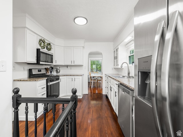 188 E 100 S, Santaquin, UT 84655 - kitchen with appliances with stainless steel finishes, arched walkways, light stone countertops, and white cabinets