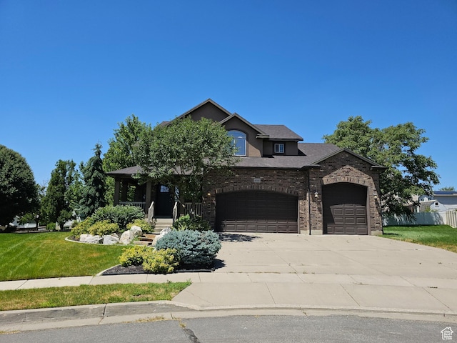 488 N 1375 E, Layton, UT 84040 - view of front of house with a front lawn, an attached garage, driveway, a porch, and brick siding