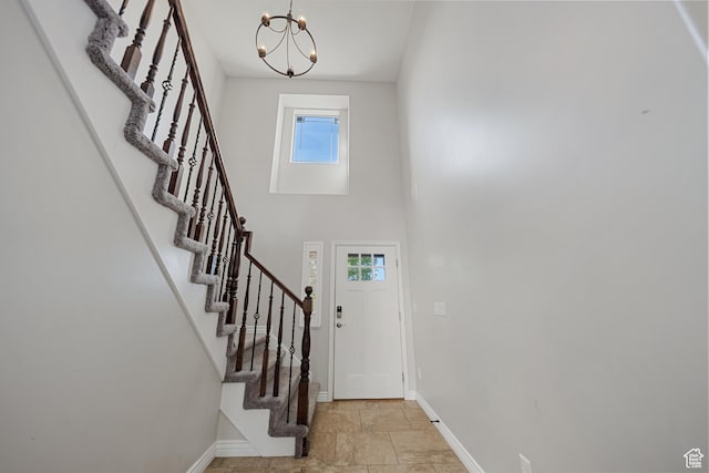 488 N 1375 E, Layton, UT 84040 - foyer entrance with stairway, plenty of natural light, a chandelier, light stone finish flooring, and a high ceiling