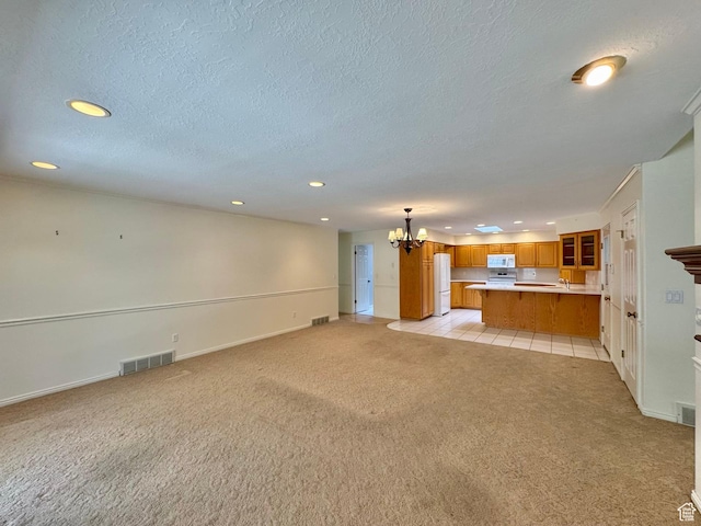1341 E 5200 S, South Ogden, UT 84403 - unfurnished living room featuring light carpet, a chandelier, recessed lighting, and a textured ceiling