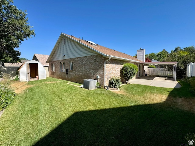1341 E 5200 S, South Ogden, UT 84403 - rear view of property featuring a patio area, a storage shed, brick siding, and a chimney