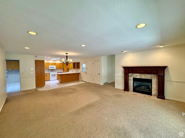 1341 E 5200 S, South Ogden, UT 84403 - unfurnished living room featuring a chandelier, light colored carpet, a fireplace, and recessed lighting