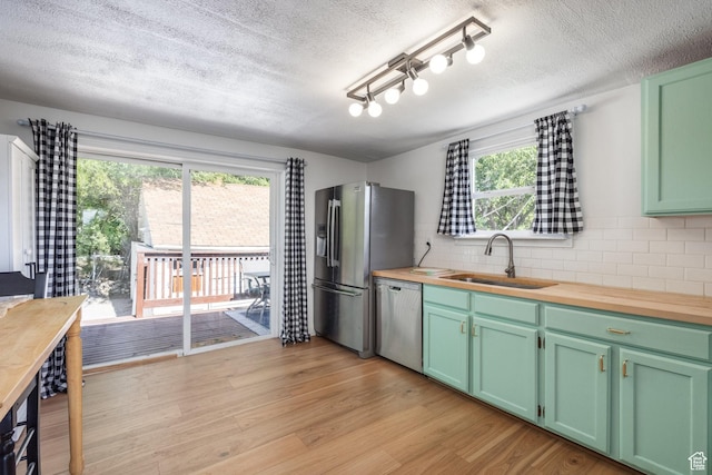 190 N 200 E, Pleasant Grove, UT 84062 - kitchen with stainless steel appliances, butcher block counters, backsplash, a textured ceiling, and light wood-type flooring