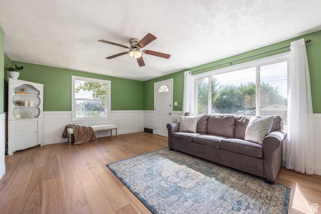 190 N 200 E, Pleasant Grove, UT 84062 - living area with wainscoting, a ceiling fan, wood finished floors, and healthy amount of natural light