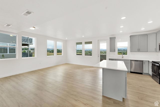 736 W Blue Magic Ln S Unit R201, Midvale, UT 84047 - kitchen featuring stainless steel appliances, gray cabinets, healthy amount of natural light, light wood-type flooring, and recessed lighting