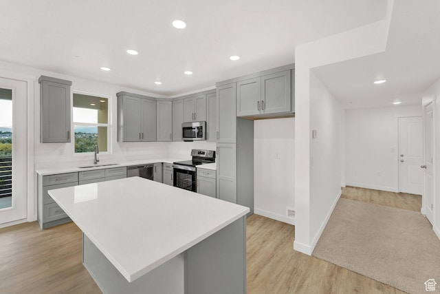 736 W Blue Magic Ln S Unit R201, Midvale, UT 84047 - kitchen with appliances with stainless steel finishes, gray cabinets, light countertops, light wood-style flooring, and recessed lighting