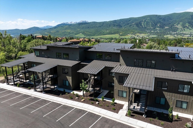 3840 N 4975 E Unit A104, Eden, UT 84310 - view of property featuring stairs, a mountain view, and uncovered parking