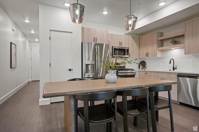 3840 N 4975 E Unit A104, Eden, UT 84310 - kitchen with stainless steel appliances, light brown cabinets, open shelves, dark wood-type flooring, and light countertops