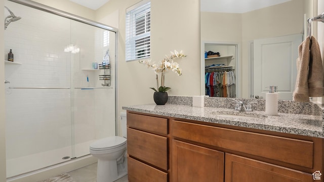 6069 W Franciscotti Dr Unit 473, South Jordan, UT 84009 - bathroom with vanity, a stall shower, a walk in closet, and tile patterned floors