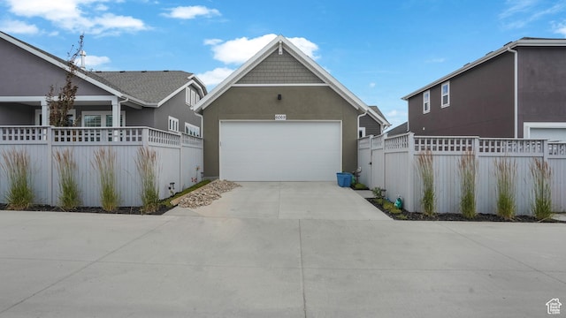 6069 W Franciscotti Dr Unit 473, South Jordan, UT 84009 - view of front facade featuring a garage, stucco siding, and concrete driveway