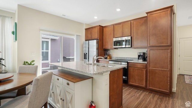6069 W Franciscotti Dr Unit 473, South Jordan, UT 84009 - kitchen featuring stainless steel appliances, dark wood finished floors, brown cabinetry, and recessed lighting