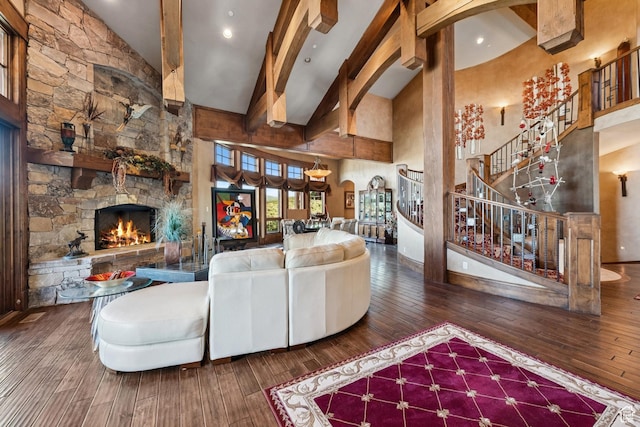 7881 N W Hills Trl, Park City, UT 84098 - living room featuring high vaulted ceiling, hardwood / wood-style flooring, stairway, a stone fireplace, and arched walkways
