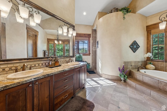 7881 N W Hills Trl, Park City, UT 84098 - bathroom featuring plenty of natural light, double vanity, a garden tub, and backsplash