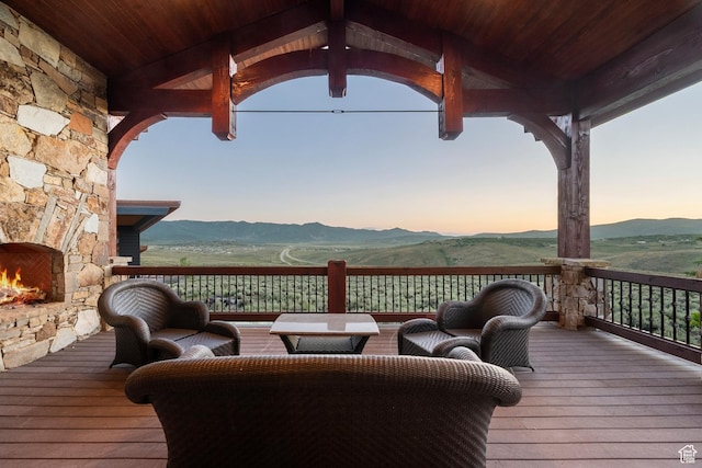 7881 N W Hills Trl, Park City, UT 84098 - deck featuring a mountain view and an outdoor stone fireplace