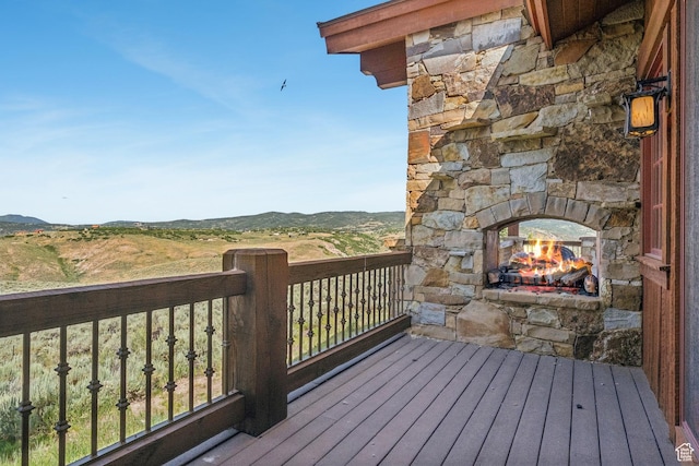 7881 N W Hills Trl, Park City, UT 84098 - wooden terrace featuring an outdoor stone fireplace and a mountain view