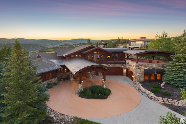 7881 N W Hills Trl, Park City, UT 84098 - view of property's community featuring curved driveway, a mountain view, and an attached garage