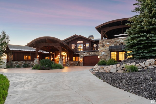 7881 N W Hills Trl, Park City, UT 84098 - view of front facade featuring stone siding, a balcony, an attached garage, and board and batten siding
