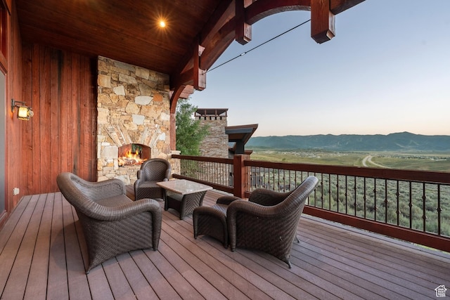 7881 N W Hills Trl, Park City, UT 84098 - wooden deck with an outdoor stone fireplace and a mountain view