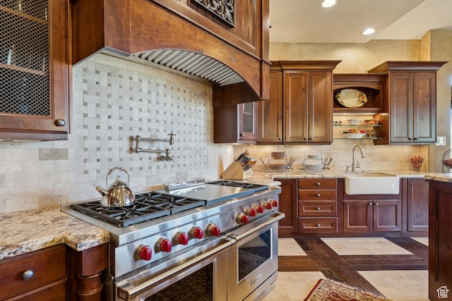 7881 N W Hills Trl, Park City, UT 84098 - kitchen with range with two ovens, inlaid floor details, light stone countertops, recessed lighting, and open shelves